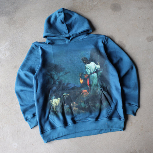 Blue hoodie with a graphic design on a gray surface