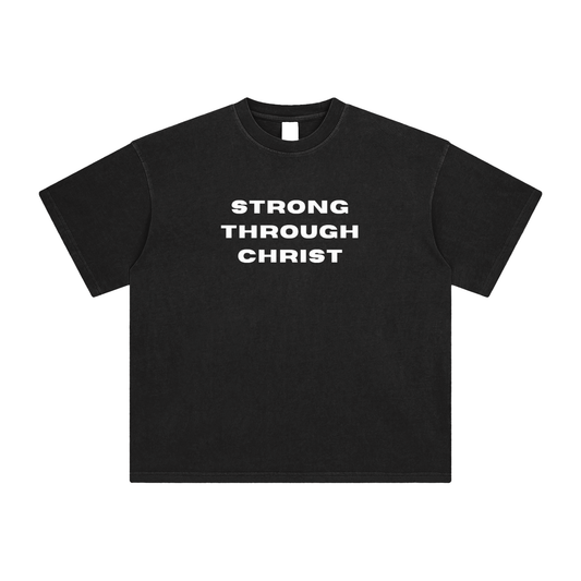 Black crew neck t-shirt with the text 'STRONG THROUGH CHRIST' printed across the chest.